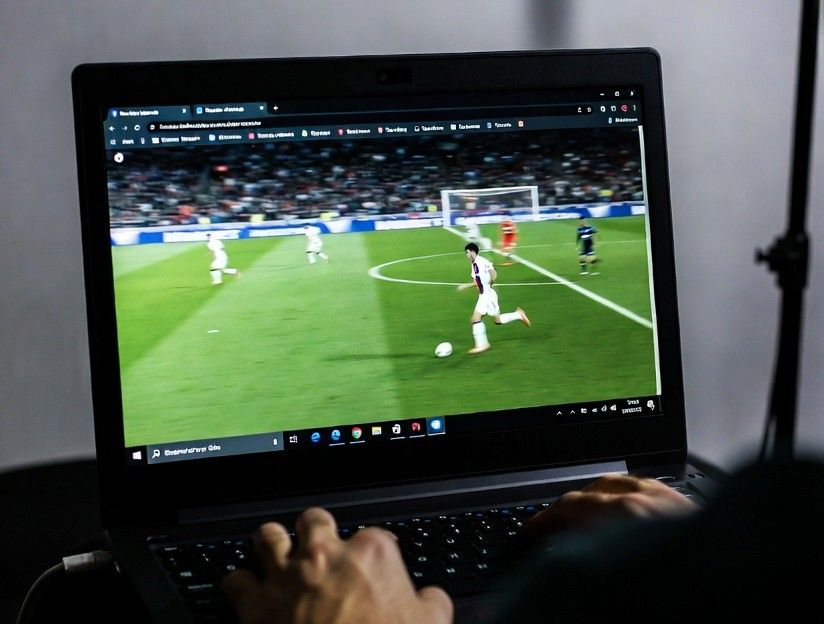A viewer watching live sports on a laptop with multiple tabs open
